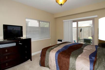 Downstairs Master bedroom includes a comfortable California King Bed, its own Television with DVD and VHS player and patio access